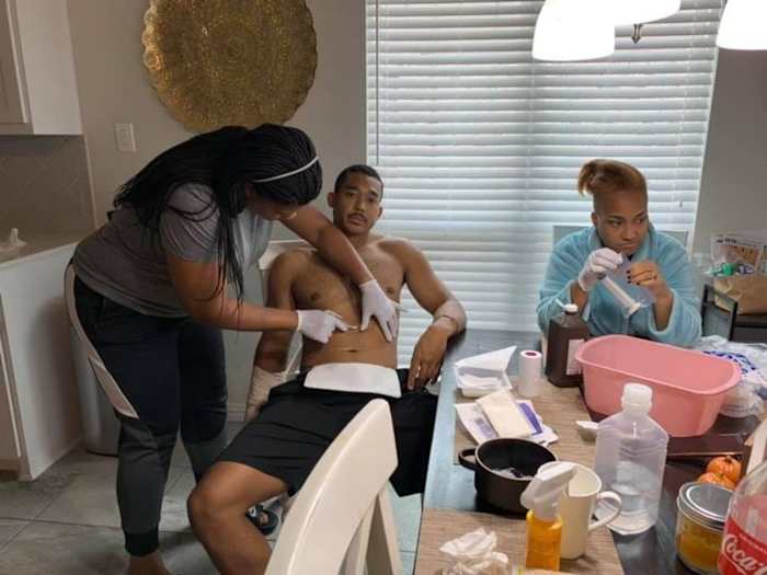 Chad Whitener having his dressing changed by nurse Sharise Lajuan.