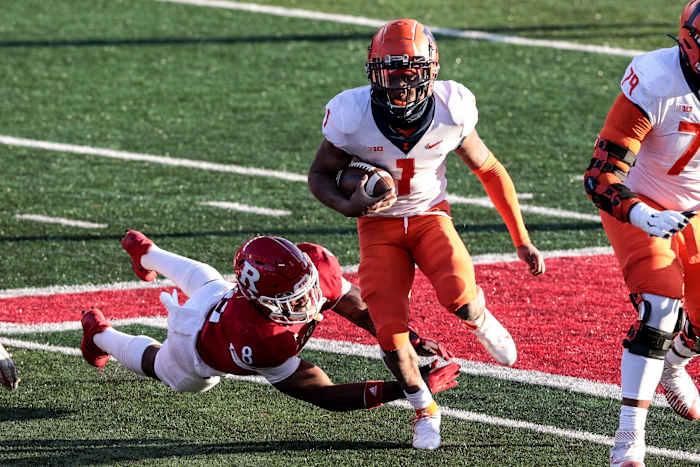 Illinois Fighting Illini quarterback Isaiah Williams (1) carries the ball as Rutgers Scarlet Knights linebacker Tyshon Fogg (8) dives for the tackle during the second half at SHI Stadium.