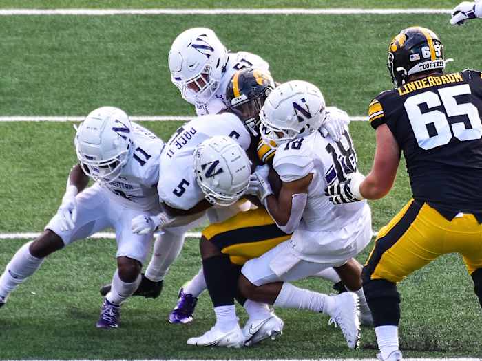 Northwestern's defense swarms an Iowa player