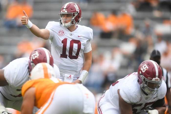 Alabama QB Mac Jones signals to a teammate before a play