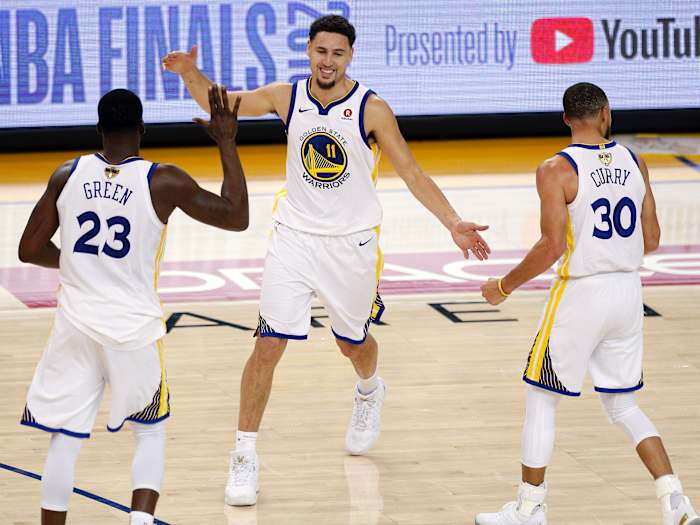 Golden State Warriors guard Klay Thompson (11) reacts with forward Draymond Green (23) and guard Stephen Curry (30) during overtime in game one of the 2018 NBA Finals at Oracle Arena.