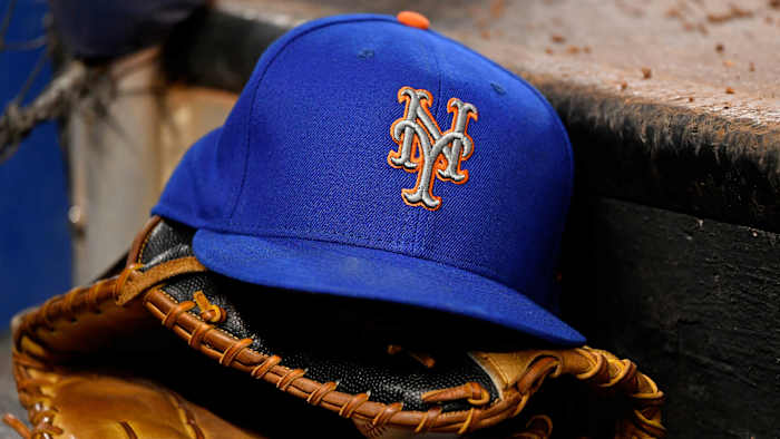 Mets hat sitting on top of glove