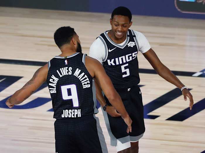 acramento Kings guard Cory Joseph (9) and guard De'Aaron Fox (5) celebrate during the first half of a NBA basketball game against the Dallas Mavericks