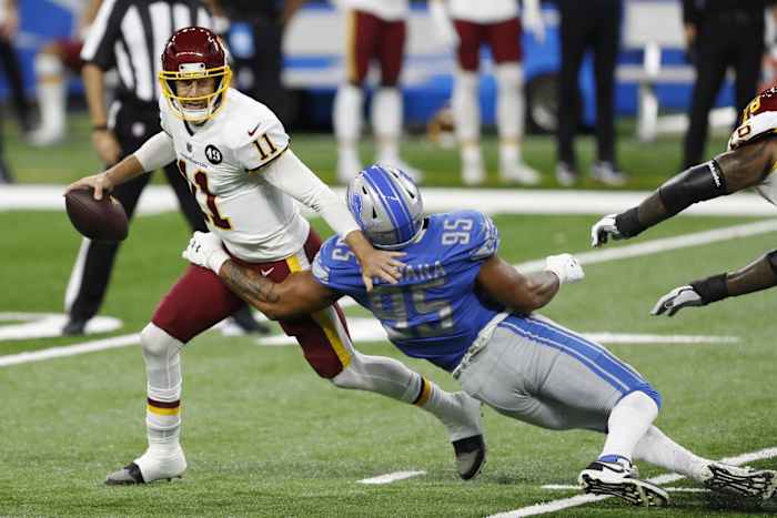 Washington Football Team quarterback Alex Smith gets sacked by Lions defensive end Romeo Okwara.