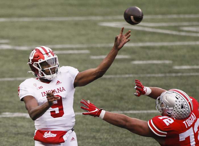 Indiana Hoosiers quarterback Michael Penix Jr. (9) passes as Ohio State Buckeyes defensive tackle Tommy Togiai (72) pressures during the fourth quarter of a NCAA Division I football game between the Ohio State Buckeyes and the Indiana Hoosiers on Saturday, Nov. 21, 2020 at Ohio Stadium in Columbus, Ohio.