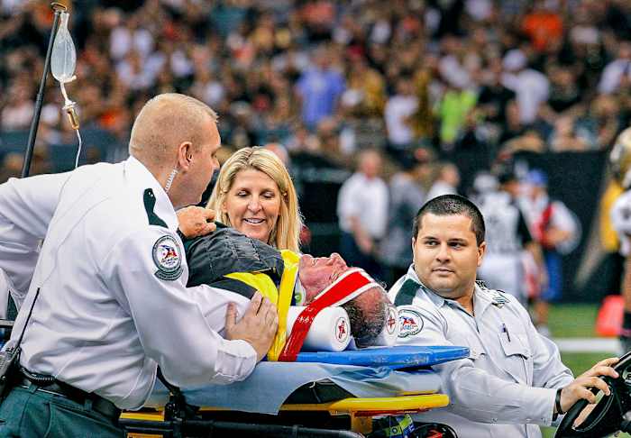 NFL chain crew member is carted off the field after suffering an injury in a collision