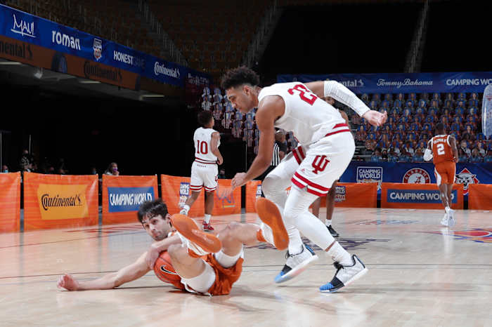 Indiana's Trayce Jackson-Davis (right) fights for a loose ball in the loss to Texas. (Photos courtesy of IU Athletics)