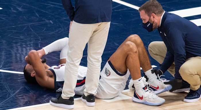 Gonzaga Bulldogs guard Jalen Suggs (1) lies down on the floor after suffering an apparent injury against the West Virginia Mountaineers in the first half at Bankers Life Fieldhouse.