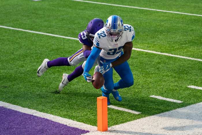 Swift is tackled by Minnesota Vikings defensive back Kris Boyd. 