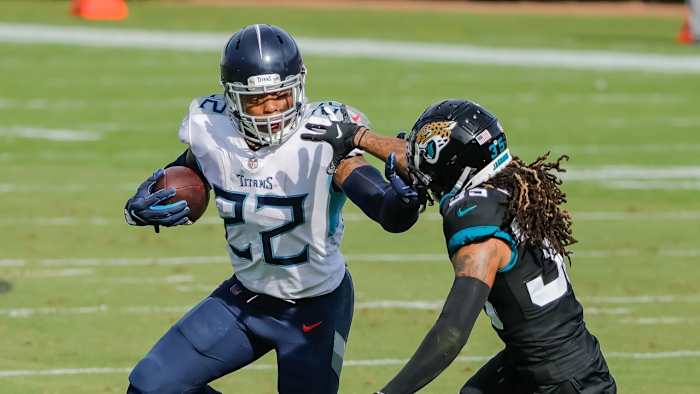 Henry runs the ball around Jacksonville Jaguars cornerback Sidney Jones.
