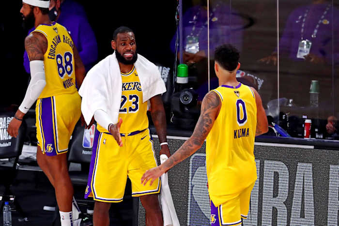 Sep 30, 2020; Orlando, Florida, USA; Los Angeles Lakers forward LeBron James (23) celebrates with forward Kyle Kuzma (0) during the fourth quarter against the Miami Heat in game one of the 2020 NBA Finals at AdventHealth Arena.