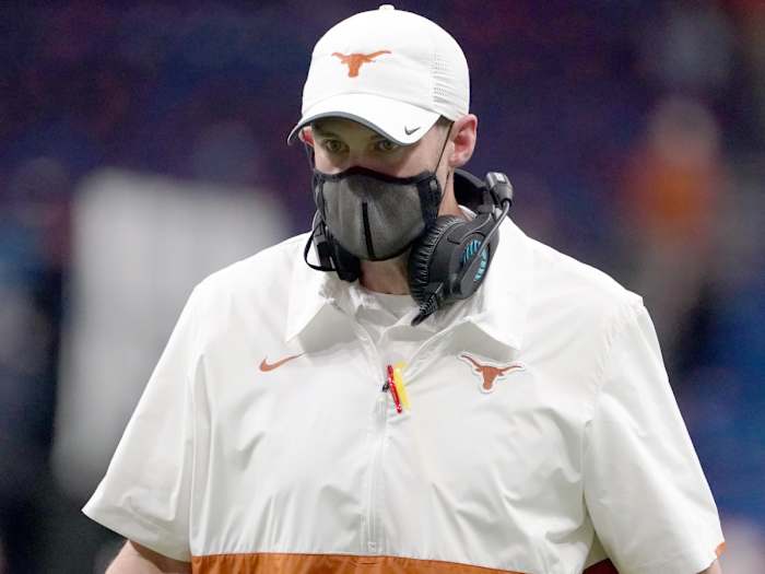 Dec 29, 2020; San Antonio, TX, USA; Texas Longhorns coach Tom Herman wears a face mask on the sidelines in the second half against the Colorado Buffaloes during the Alamo Bowl at the Alamodome.