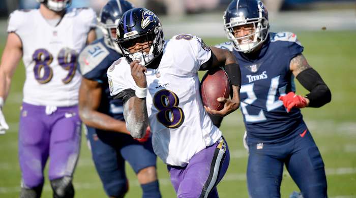 Baltimore Ravens quarterback Lamar Jackson (8) runs for a touchdown during the Tennessee Titans game against the Baltimore Ravens in Nashville on January 10, 2021.