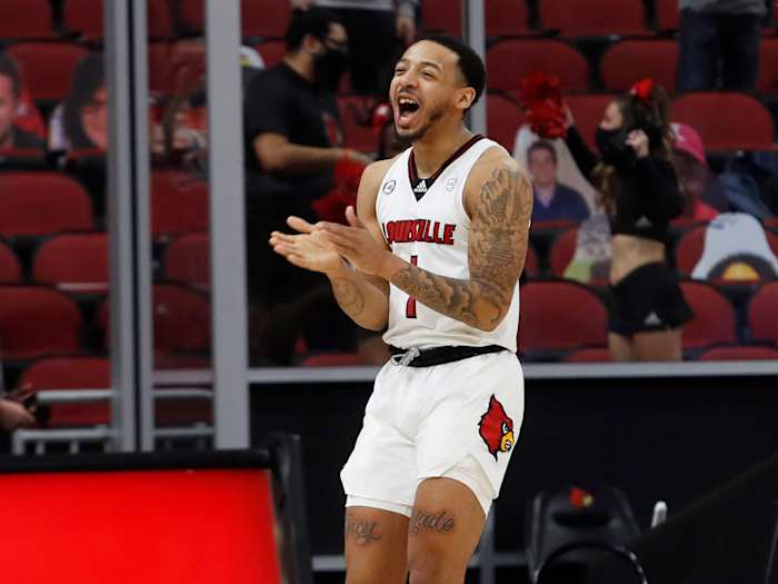 Louisville's Carlik Jones claps during a game