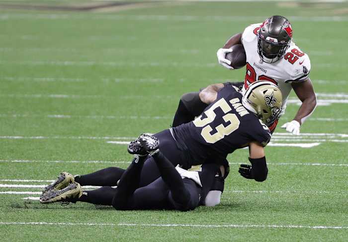 Jan 17, 2021; New Orleans, LA, USA; Buccaneers running back Leonard Fournette (28) is tackled by Saints linebacker Zack Baun (53) during the first quarter in a NFC Divisional Round playoff game at Mercedes-Benz Superdome. Mandatory Credit: Derick E. Hingle-USA TODAY Sports