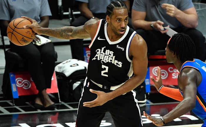 Jan 22, 2021; Los Angeles, California, USA; LA Clippers forward Kawhi Leonard (2) keeps the ball away from Oklahoma City Thunder forward Luguentz Dort (5) during the fourth qiuarter at Staples Center. Mandatory Credit: Robert Hanashiro-USA TODAY Sports