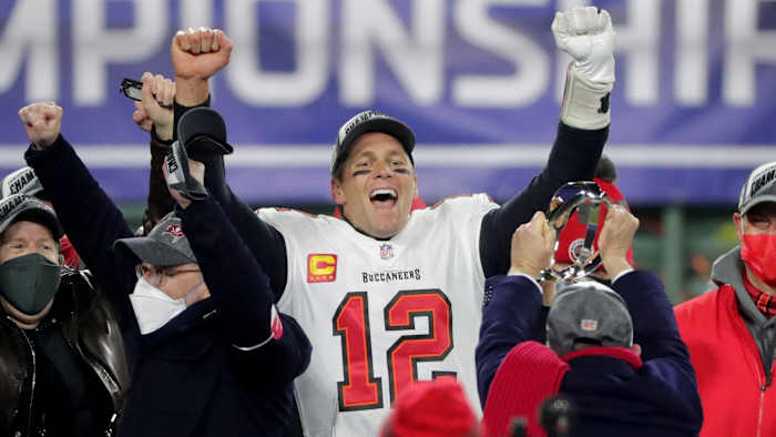 Tampa Bay Buccaneers quarterback Tom Brady (12) exalts during the presentation off the George Halas Trophy after their NFC Championship game Sunday, January 24, 2021 at Lambeau Field in Green Bay