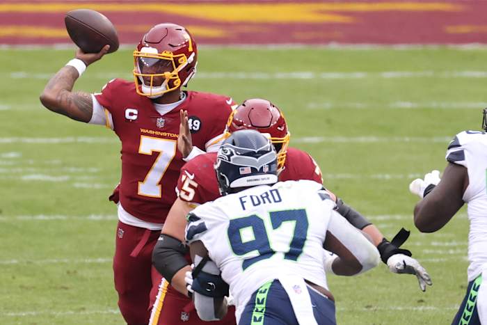 Washington Football Team quarterback Dwayne Haskins Jr. (7) passes the ball as Seattle Seahawks defensive tackle Poona Ford (97) defends in the second quarter at FedExField. The back of Ford's helmet reads, "Breonna Taylor." © Geoff Burke-USA TODAY Sports