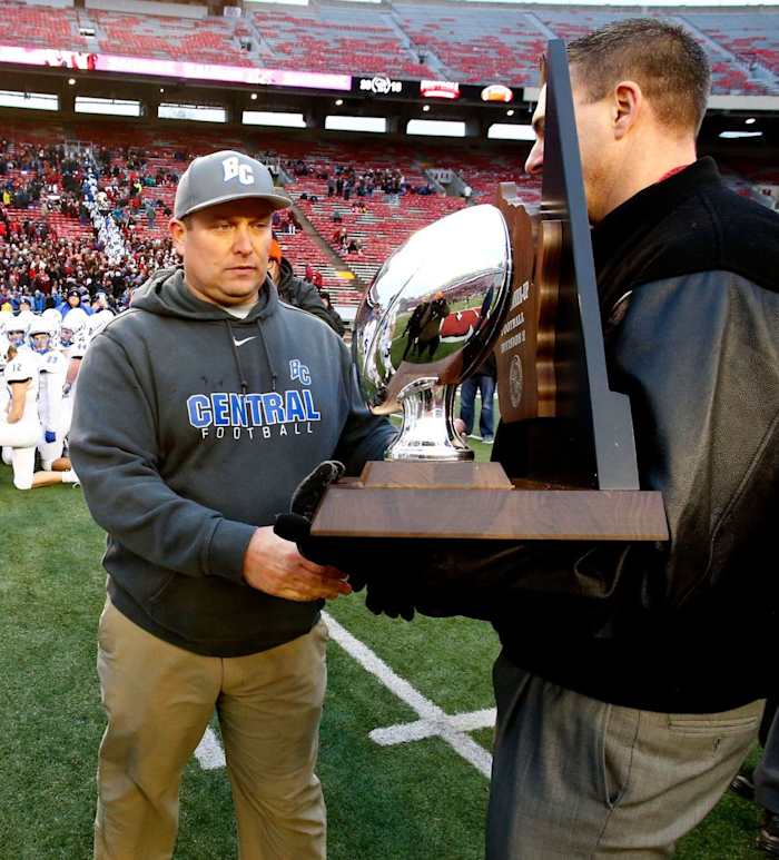 Brookfield (WIs.) Central High School football coach Jed Kennedy accepts the 2018 WIAA Division 2 runner-up trophy following the team's 51-14 loss to Homestead in Madison on Nov. 16.