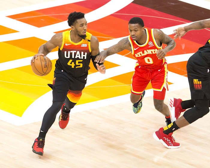 Donovan Mitchell (45) leading the Utah Jazz offense against Brandon Goodwin (0) and the Atlanta Hawks