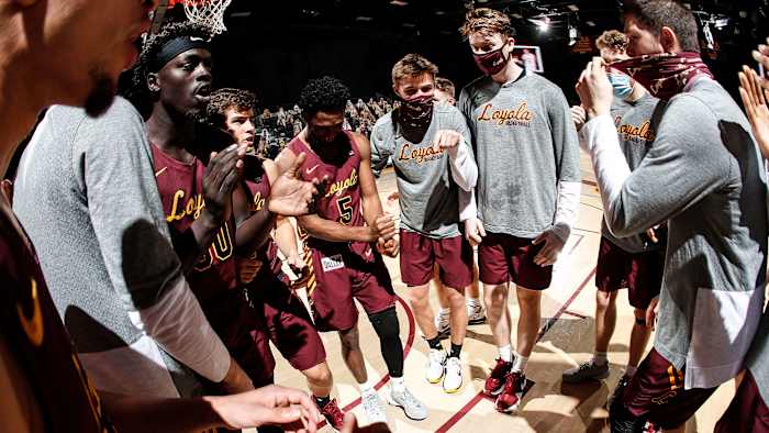 Loyola Chicago basketball gathers in a huddle