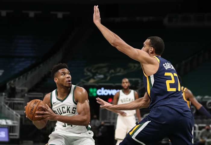 Rudy Gobert (27) defends Giannis Antetokounmpo (34) 