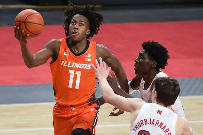Illinois Fighting Illini guard Ayo Dosunmu (11) scores against Nebraska Cornhuskers center Eduardo Andre (35) and guard Thorir Thorbjarnarson (34) in the second half at Pinnacle Bank Arena.