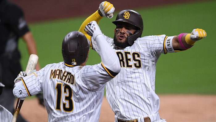 Fernando Tatis Jr. and Manny Machado celebrate against the Cardinals at Petco Park.