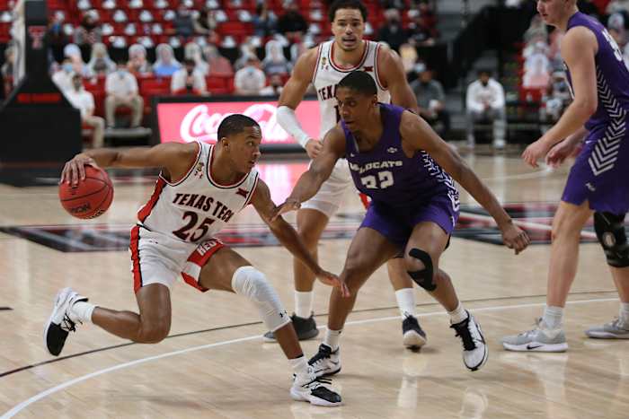 Texas Tech Red Raiders guard Nimari Burnett (25) looks for an opening against Abilene Christian Wildcats forward Joe Pleasant (32) at United Supermarkets Arena in a Dec. 9, 2020 game.