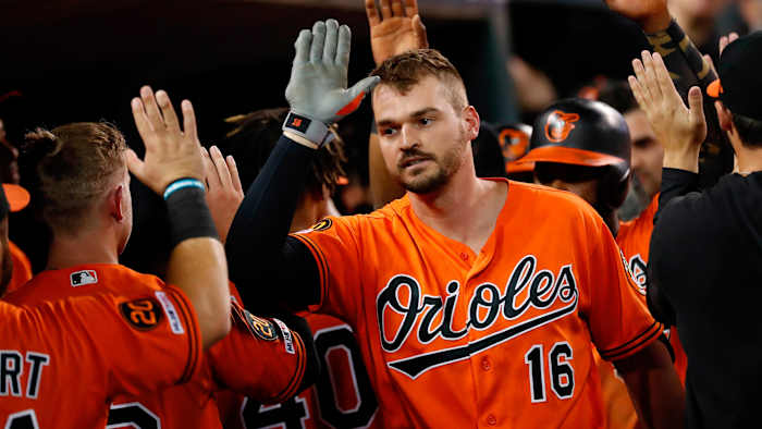 Trey Mancini high fives Orioles teammates in the dugout