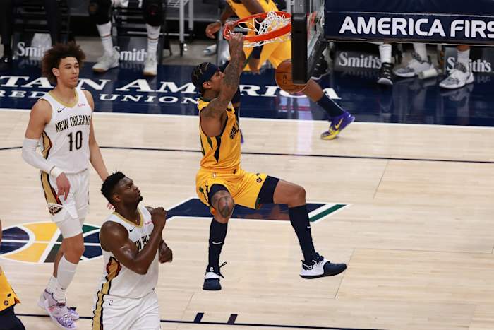 Jordan Clarkson (00) dunks over Zion Williamson (1) 