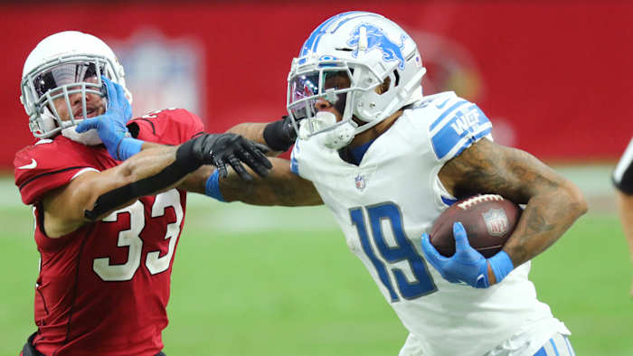 Lions receiver Kenny Golladay stiff-arms a defender during a win over the Cardinals