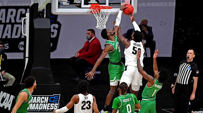 Thomas Bell blocks a shot by Trevion Williams.