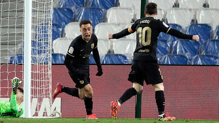 Sergiño Dest celebrates with Lionel Messi after scoring for Barcelona