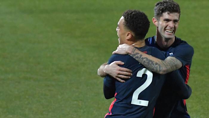 Sergino Dest and Christian Pulisic celebrate a USA goal vs Jamaica