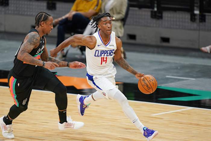 Mar 25, 2021; San Antonio, Texas, USA; Los Angeles Clippers guard Terance Mann (14) dribbles in front of San Antonio Spurs forward DeMar DeRozan (10) in the second half at the AT&T Center. Mandatory Credit: Daniel Dunn-USA TODAY Sports