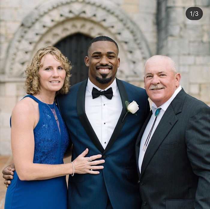 Mostert at his 2017 wedding with his Pop Warner coach Mike "Porkchop" Stokes and his wife DeAnne. (Shea Christine Photography)