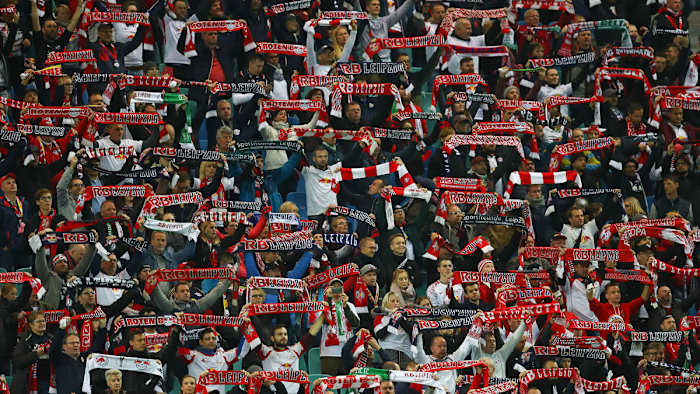RB Leipzig fans raise their scarves at Red Bull Arena