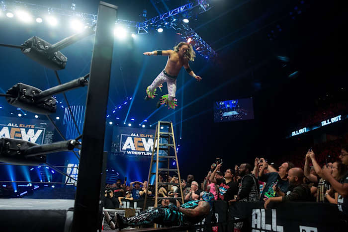 Nick Jackson of the Young Bucks dives onto Pentagon Jr. during their ladder match at AEW All Out