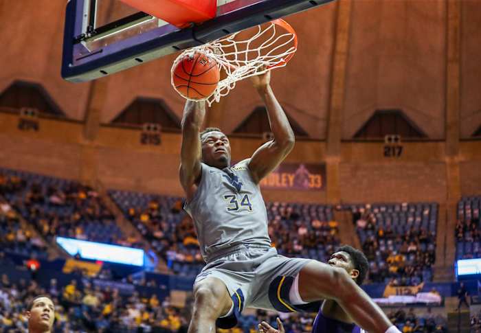 West Virginia Mountaineers forward Oscar Tshiebwe (34) dunks the ball during the second half against the TCU Horned Frogs at WVU Coliseum.
