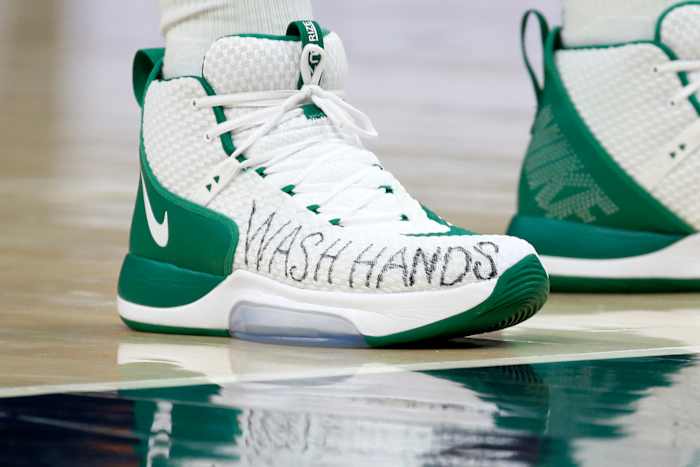 Boston Celtics center Enes Canter wears a message on his shoes for people to wash their hands.