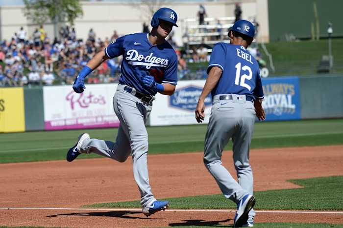 Mar 8, 2020; Surprise, Arizona, USA; Los Angeles Dodgers outfielder Cody Thomas (95) slaps hands with third base coach Dino Ebel (12) after hitting a two run home run against the Texas Rangers during the second inning of a spring training game at Surprise Stadium. Mandatory Credit: Joe Camporeale-USA TODAY Sports