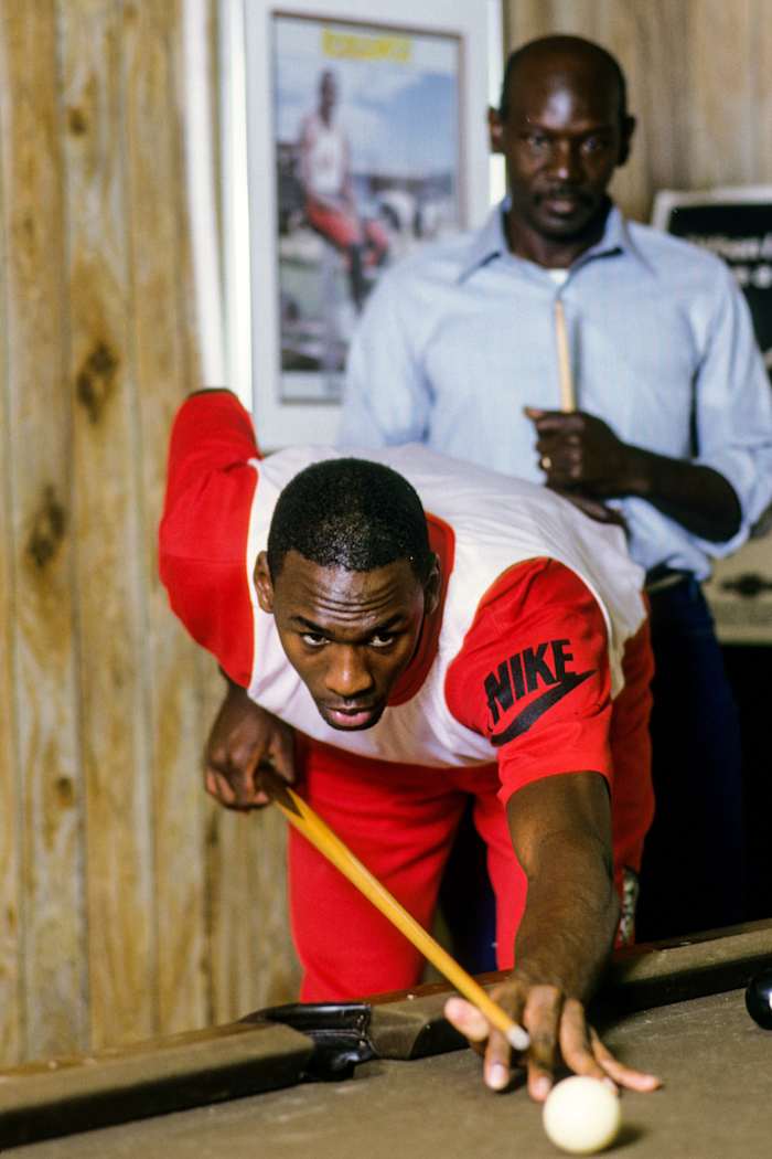 James, the man behind MJ, playing pool with heir Jordan in 1986.