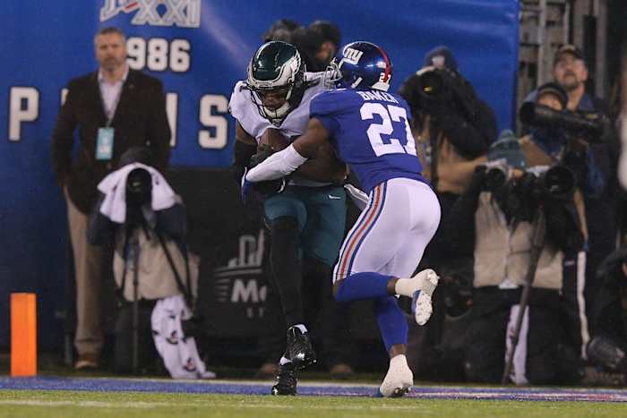 Dec 29, 2019; East Rutherford, New Jersey, USA; Philadelphia Eagles tight end Josh Perkins (81) catches a touchdown pass against New York Giants cornerback DeAndre Baker (27) during the second quarter at MetLife Stadium.