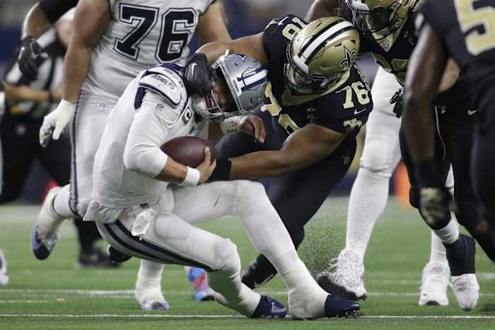Nov 29, 2018; Arlington, TX, USA; Dallas Cowboys quarterback Dak Prescott (4) is tackled by New Orleans Saints defensive tackle Taylor Stallworth (76) in the fourth quarter at AT&T Stadium. Mandatory Credit: Tim Heitman-USA TODAY Sports