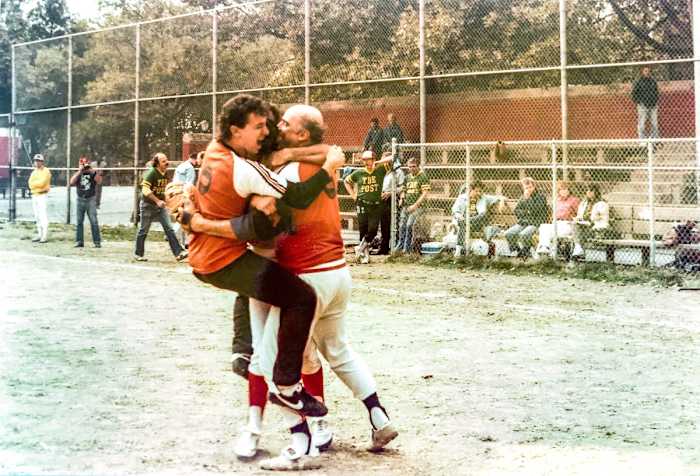 McMane (right) and UPI teammate Joel Sherman celebrate winning the 1984 title over the Post (for whom Sherman is now a baseball columnist) at the league's alternate field on 54th St. and 11th Ave.