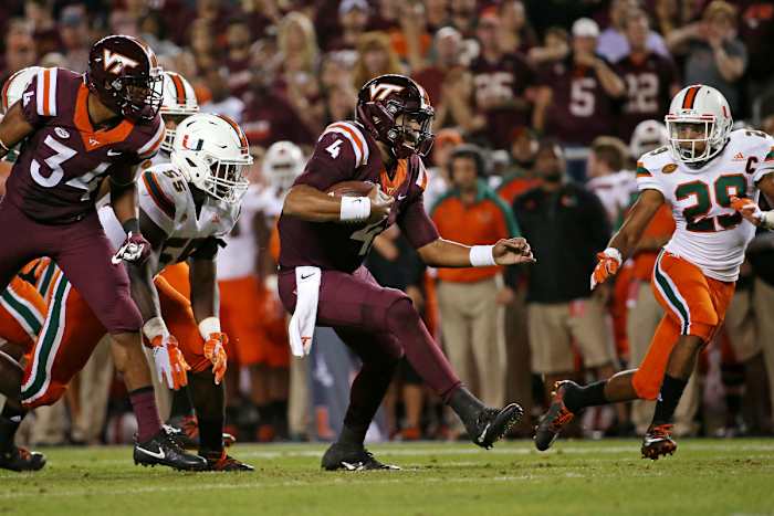 Oct 20, 2016; Blacksburg, VA, USA; Virginia Tech Hokies quarterback Jerod Evans (4) runs the ball against Miami Hurricanes defensive back Corn Elder (29) during the second quarter at Lane Stadium. Mandatory Credit: Peter Casey-USA TODAY Sports