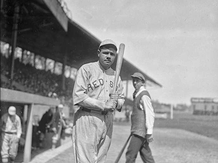 Red Sox hitter Babe Ruth holds a bat.