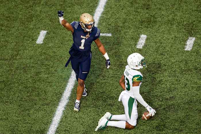 Navy Midshipmen linebacker Jacob Springer (1) reacts after a play against South Florida Bulls wide receiver Eddie McDoom (13) during the first half at Navy-Marine Corps Memorial Stadium. (Scott Taetsch-USA TODAY Sports)