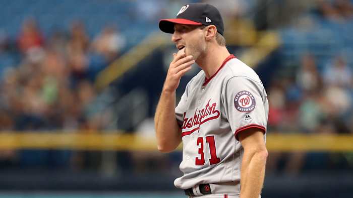 Nationals pitcher Max Scherzer licks his fingers on the mound